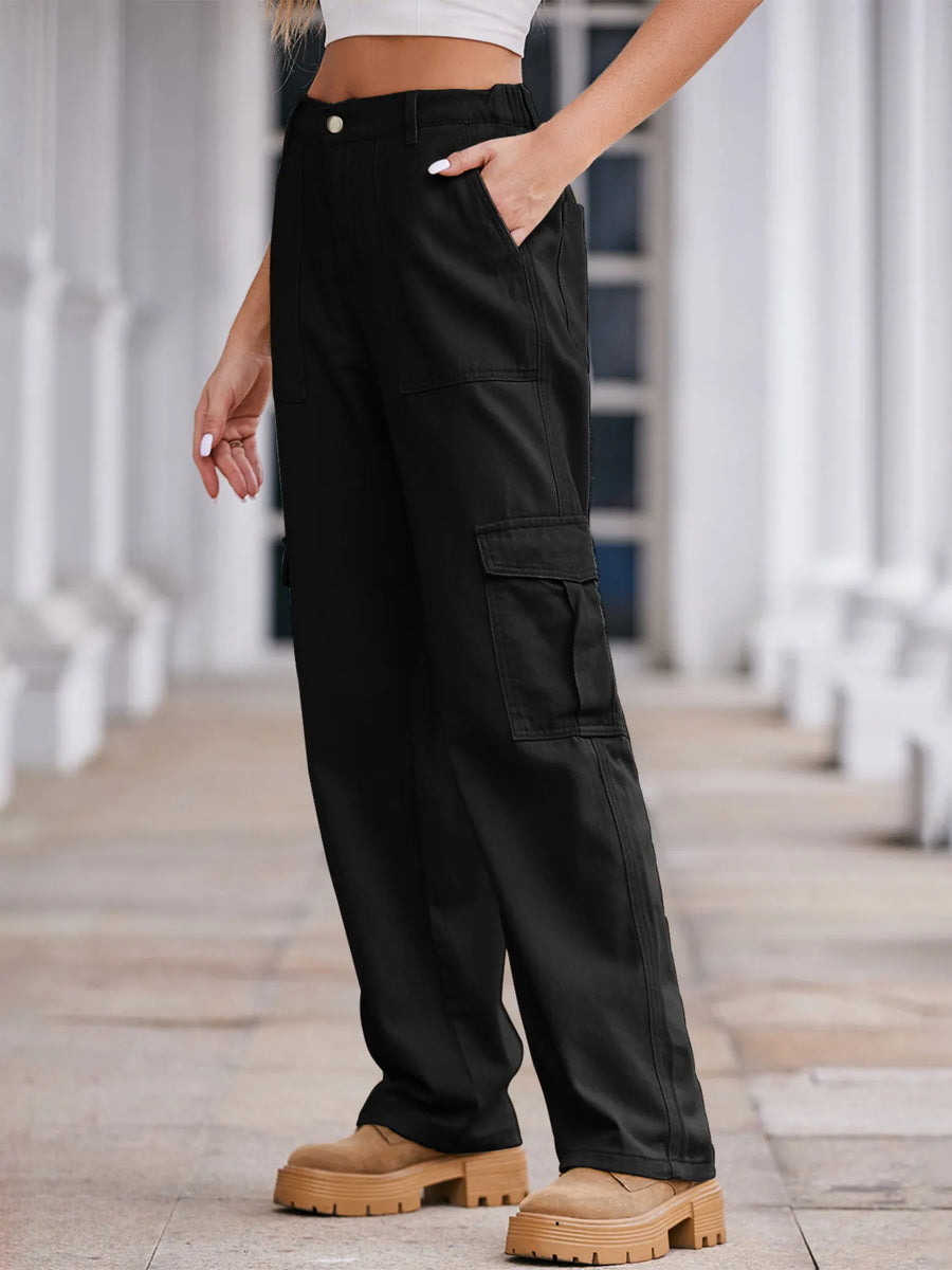 Person wearing black cargo pants with a blurred background