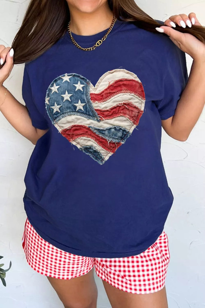 Person wearing a navy blue t-shirt with a heart-shaped American flag design and red and white checkered shorts on a white background.