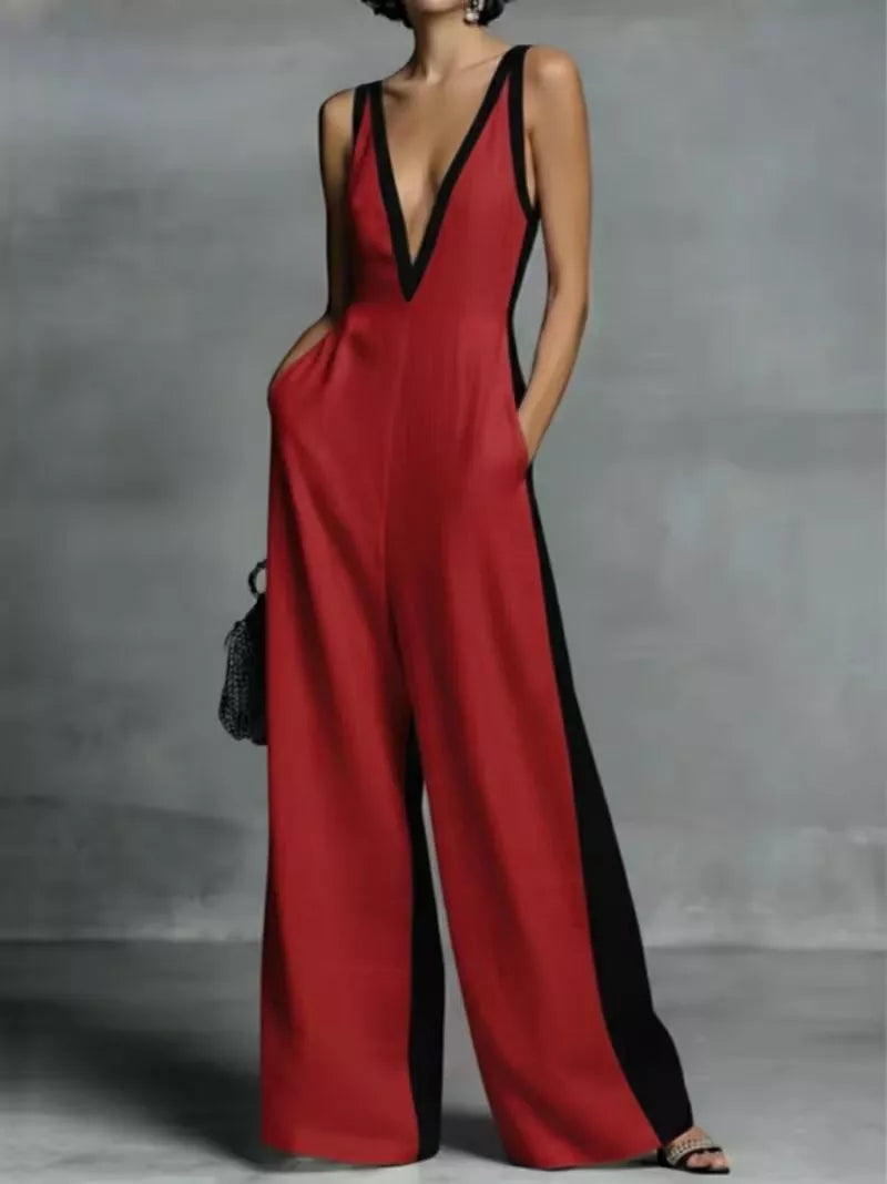 Red jumpsuit with black accents worn by a person against a gray background