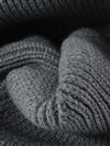 Close-up of gray knitted fabric with a textured pattern