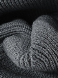 Close-up of gray knitted fabric with a textured pattern