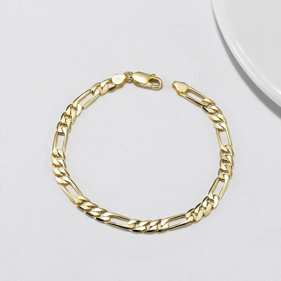Gold chain bracelet on a light gray background