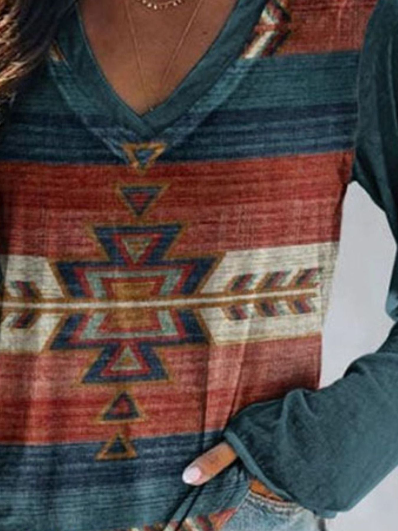 Person wearing a patterned sweater with geometric design