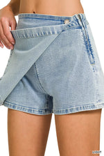 Light blue denim shorts being worn on a white background