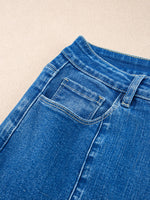 Close-up of blue denim jeans on a beige background