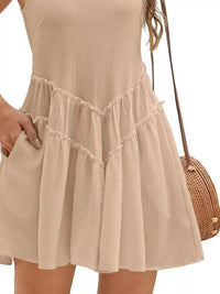 Beige dress worn by a person with a neutral background