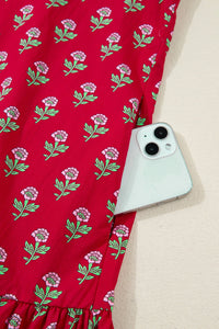Red fabric with floral pattern holding a smartphone on a beige surface