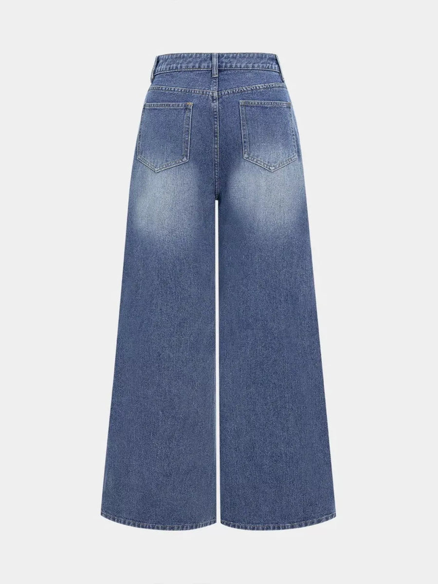 Blue wide-leg jeans on a light gray background