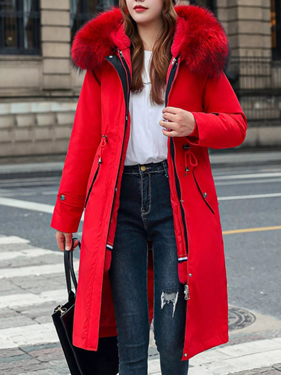 lady wearing a red Women's Detachable Longline Hooded Parka with Faux Fur Trim and Drawstring Waist sanding on a sidewalk