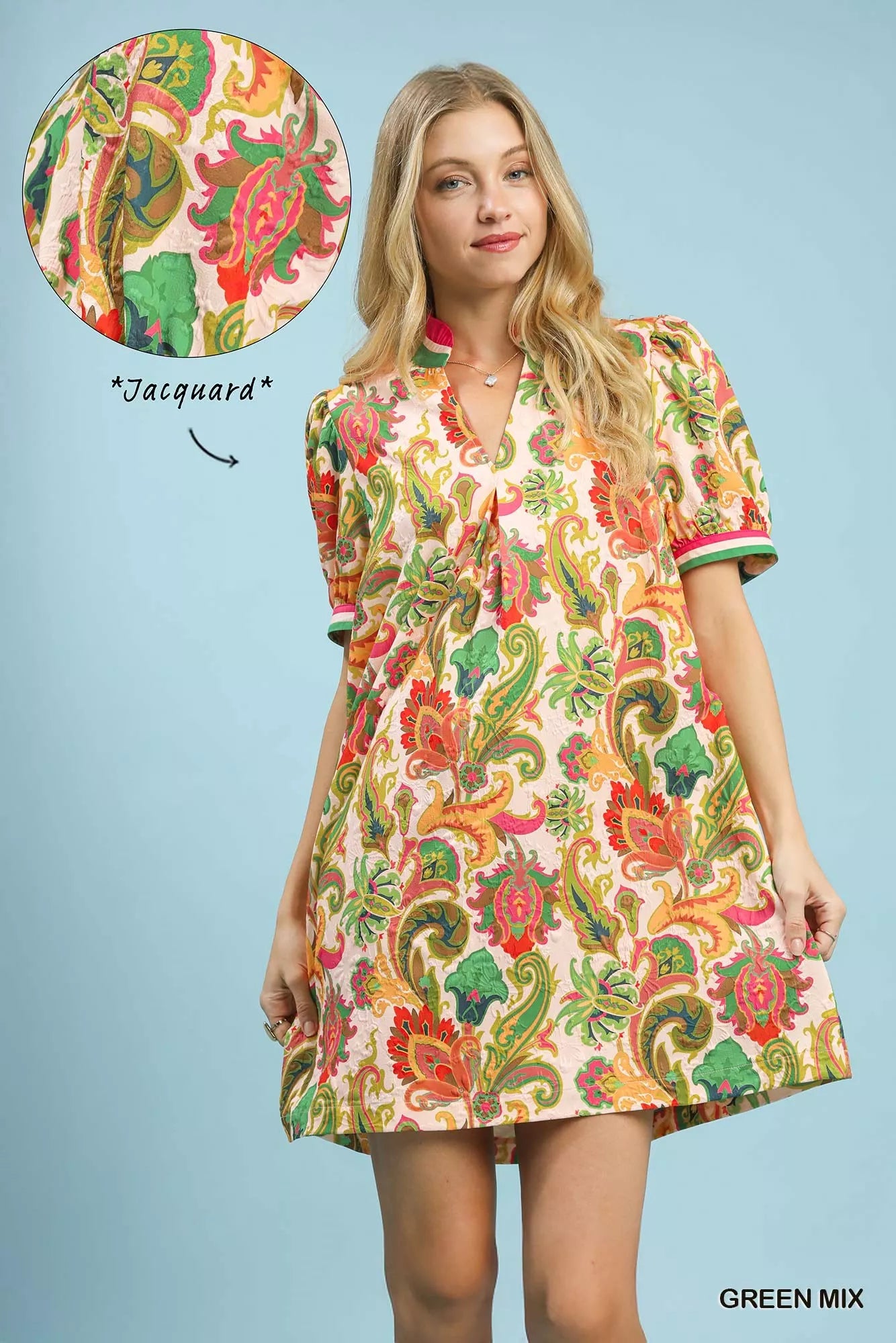Woman wearing a colorful paisley dress with a close-up of the fabric texture on a light blue background.