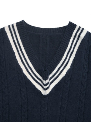 Navy sweater with a white V-neckline on a white background