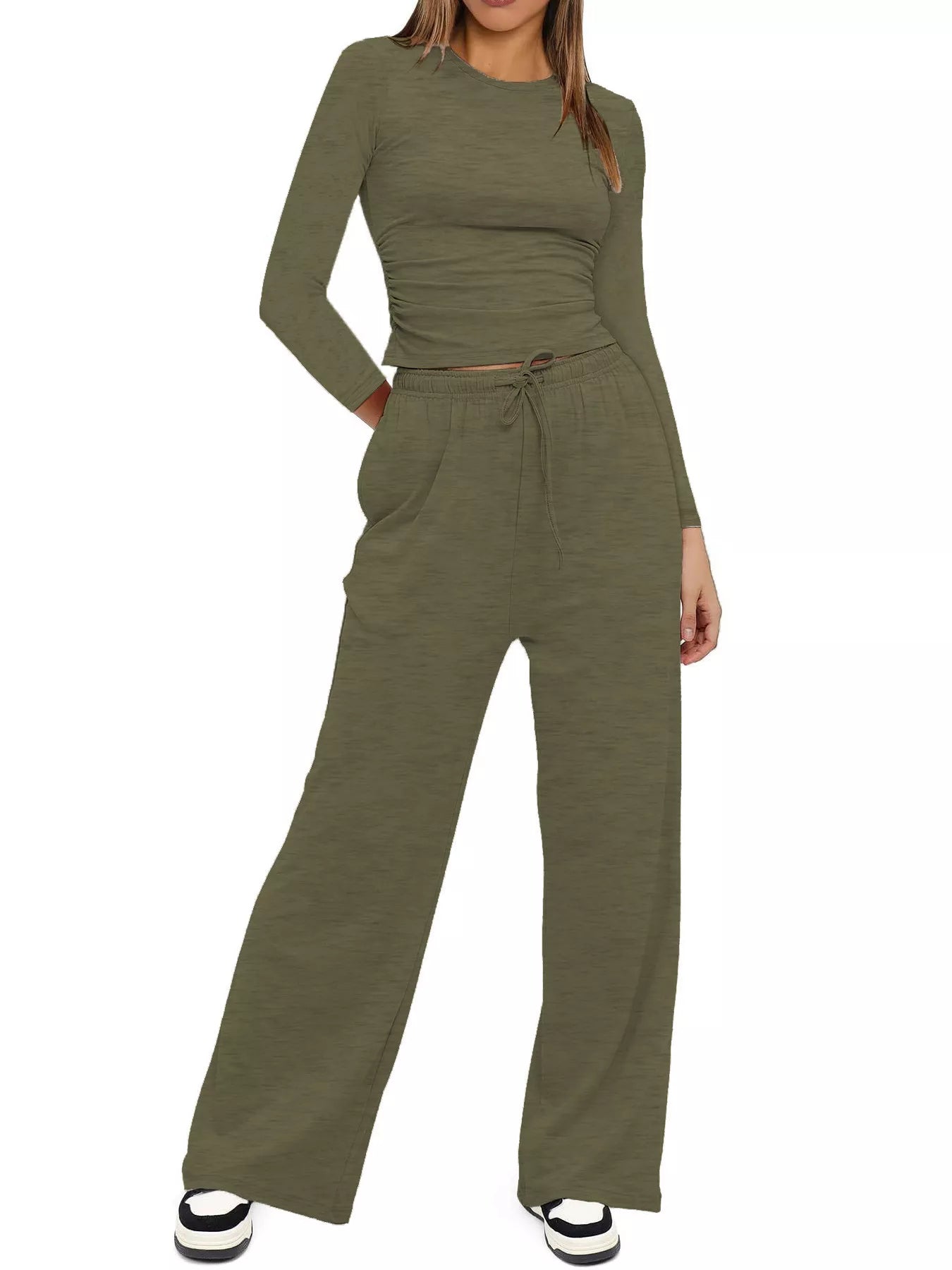 Green jumpsuit worn by a model on a white background