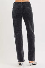 Black jeans worn by a person on a white background