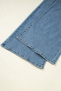 Folded blue denim jeans on a light beige background