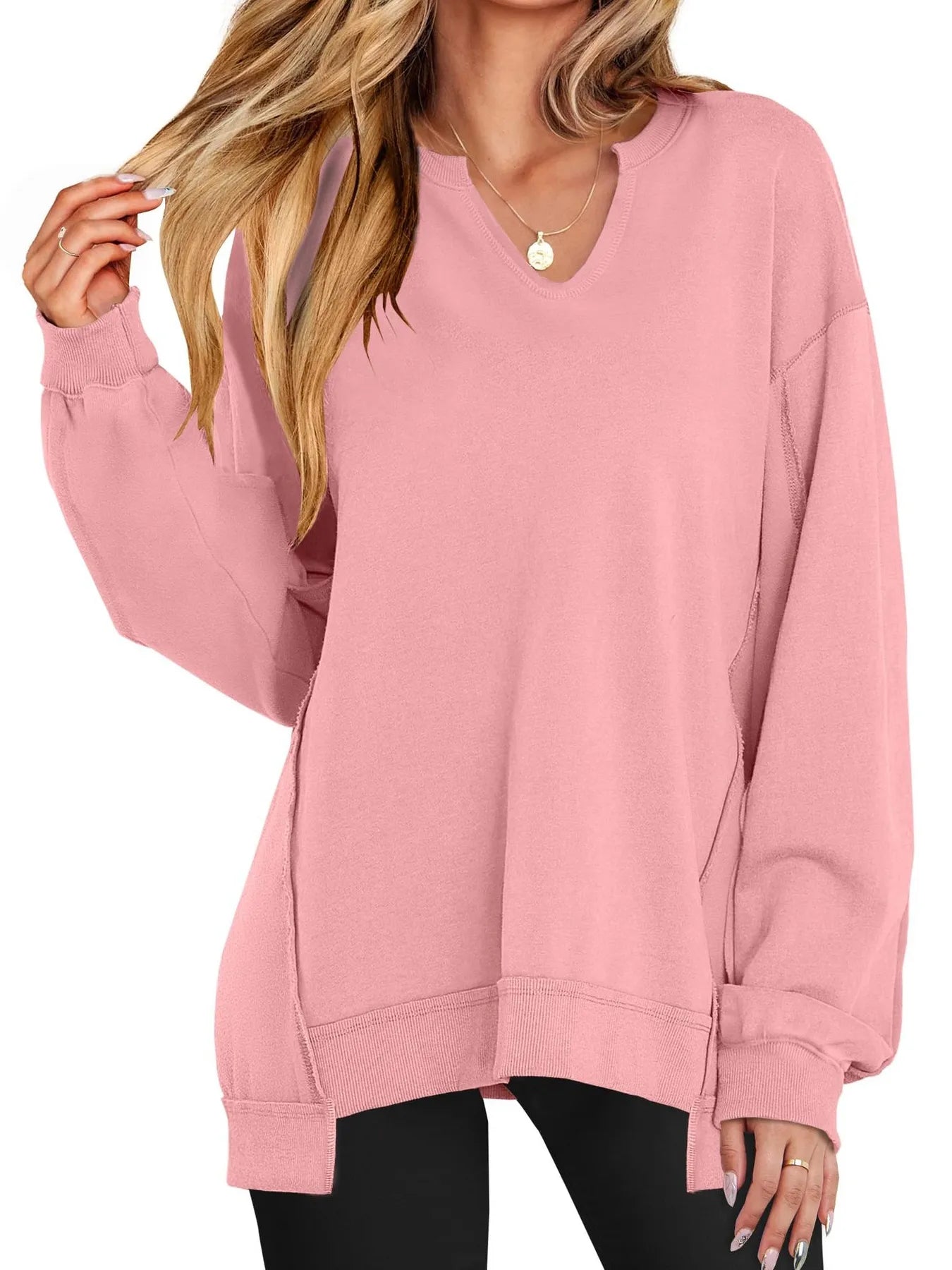 Pink sweatshirt worn by a person on a white background