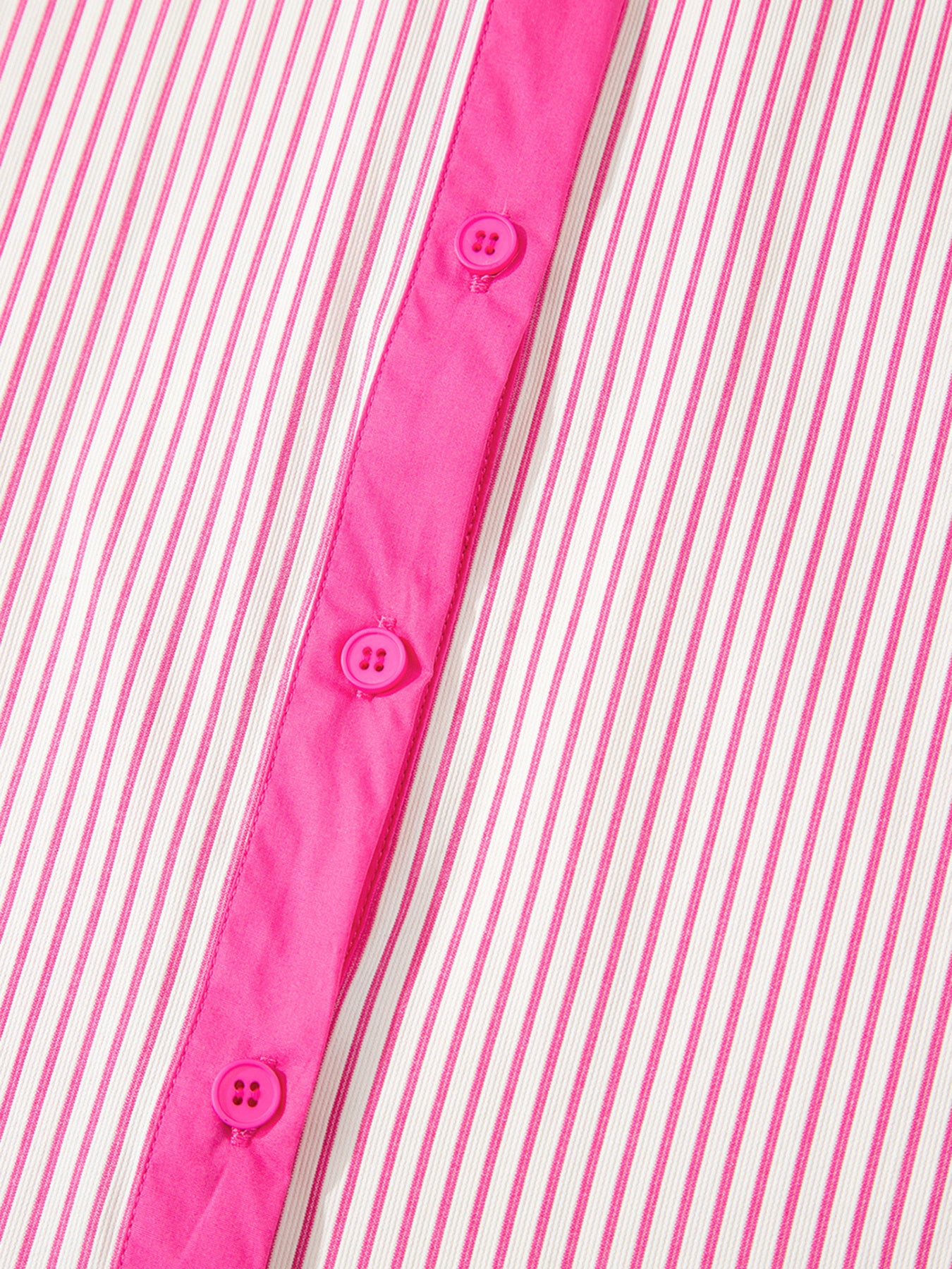 Close-up of a pink and white striped shirt with button details.