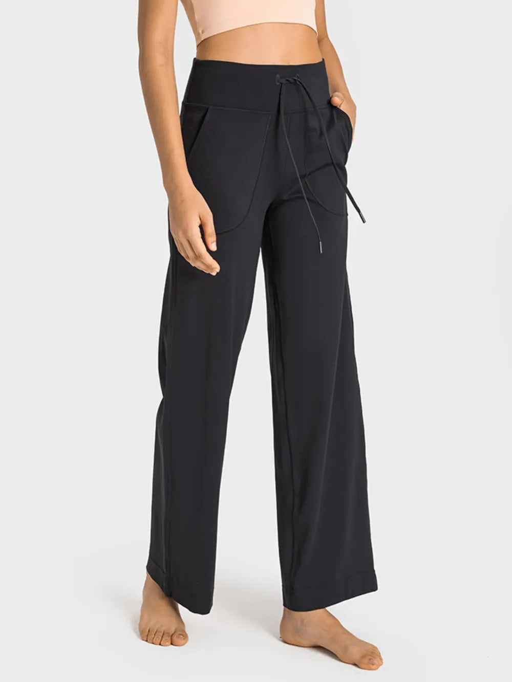 Black wide-leg pants with a tie detail on a white background