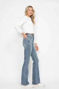 Woman wearing a white top and blue jeans on a white background