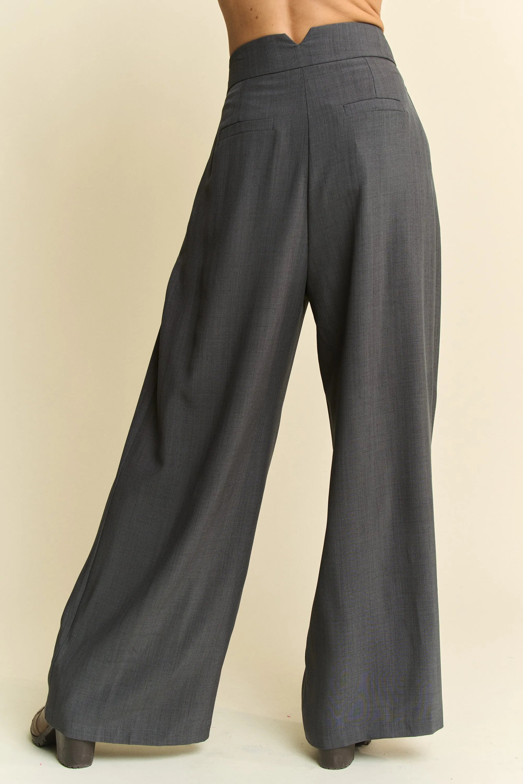 Dark gray wide-leg pants on a beige background