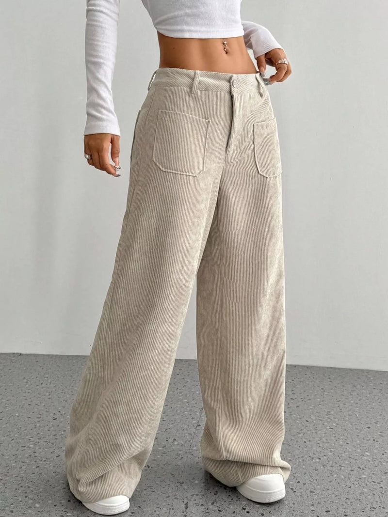 Person wearing beige corduroy wide-leg pants against a plain background