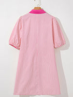 Pink and white striped dress on a mannequin against a white background