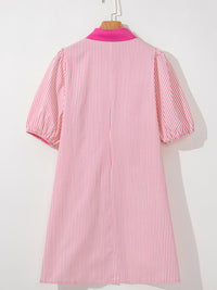 Pink and white striped dress on a mannequin against a white background