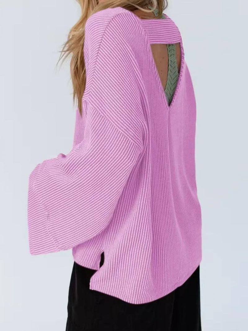 Pink sweater with a cut-out design on a white background