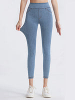 Blue jeans worn by a person on a white background