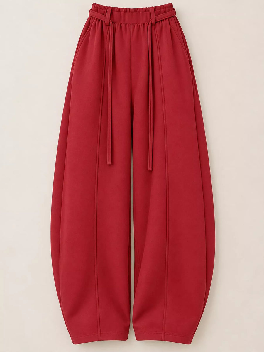 Red wide-leg harem pants with an elastic drawstring waist, shown flat against a light beige background.