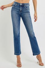 Blue jeans worn by a person on a white background