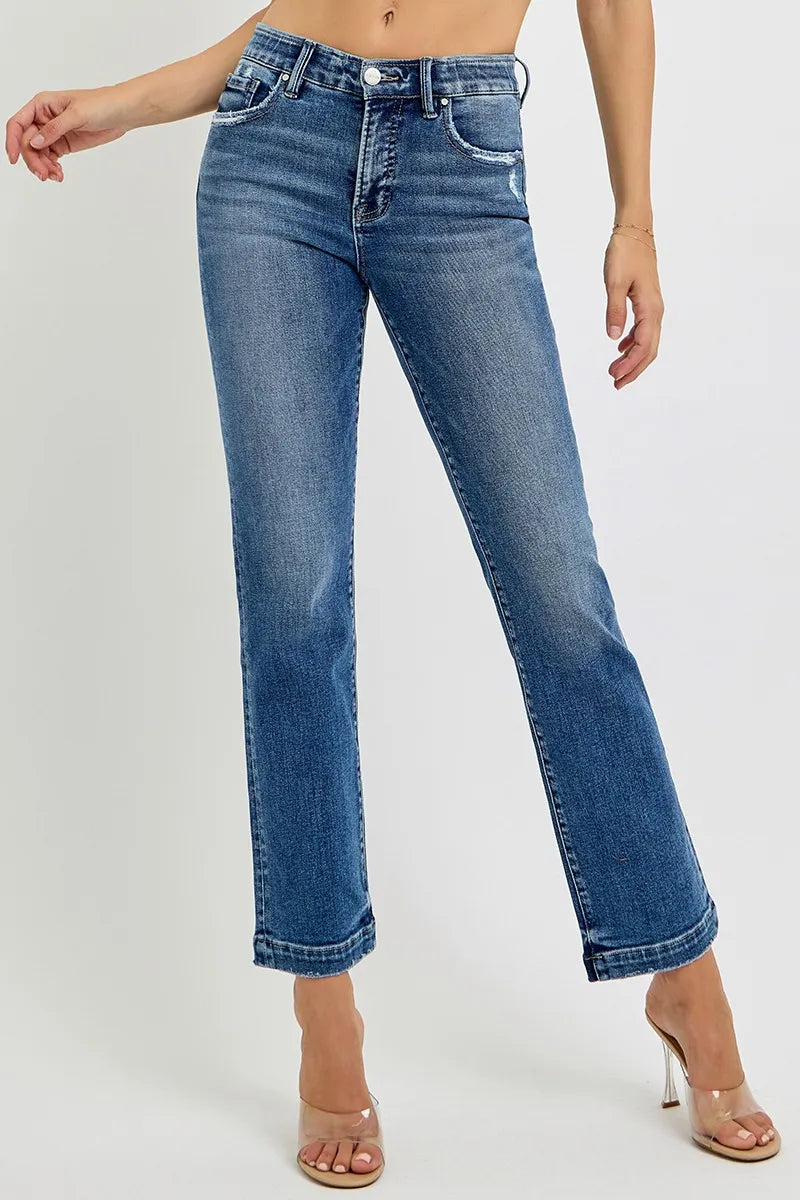 Blue jeans worn by a person on a white background