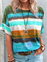 Person wearing a colorful striped shirt with a neutral background