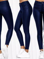 Navy blue jeans worn by a person on a white background