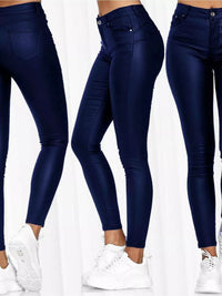 Navy blue jeans worn by a person on a white background