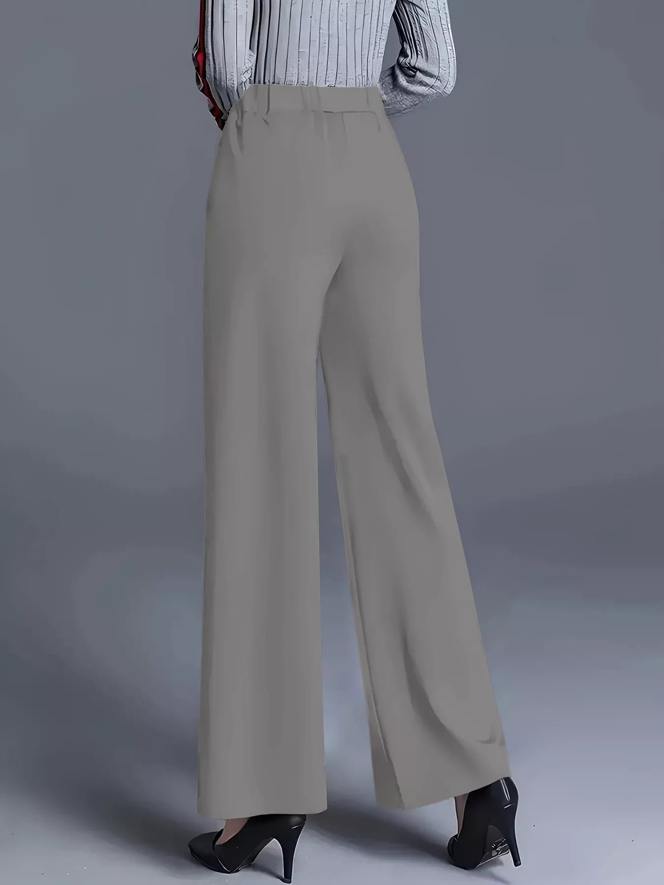 Beige wide-leg pants worn by a person on a gray background