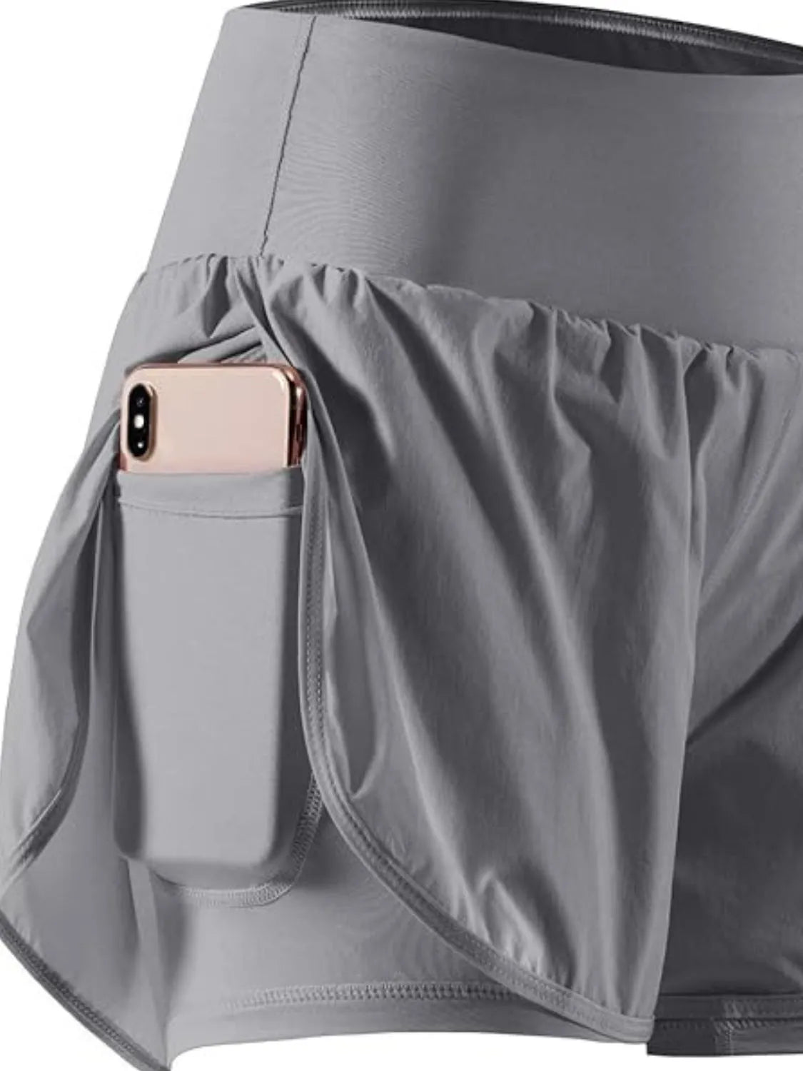 Gray athletic skirt with a pocket holding a phone on a white background