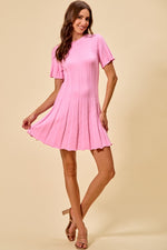 Woman wearing a pink dress on a beige background