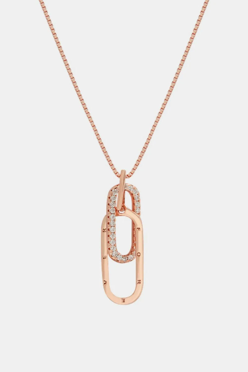 Rose gold necklace with a unique pendant on a light gray background