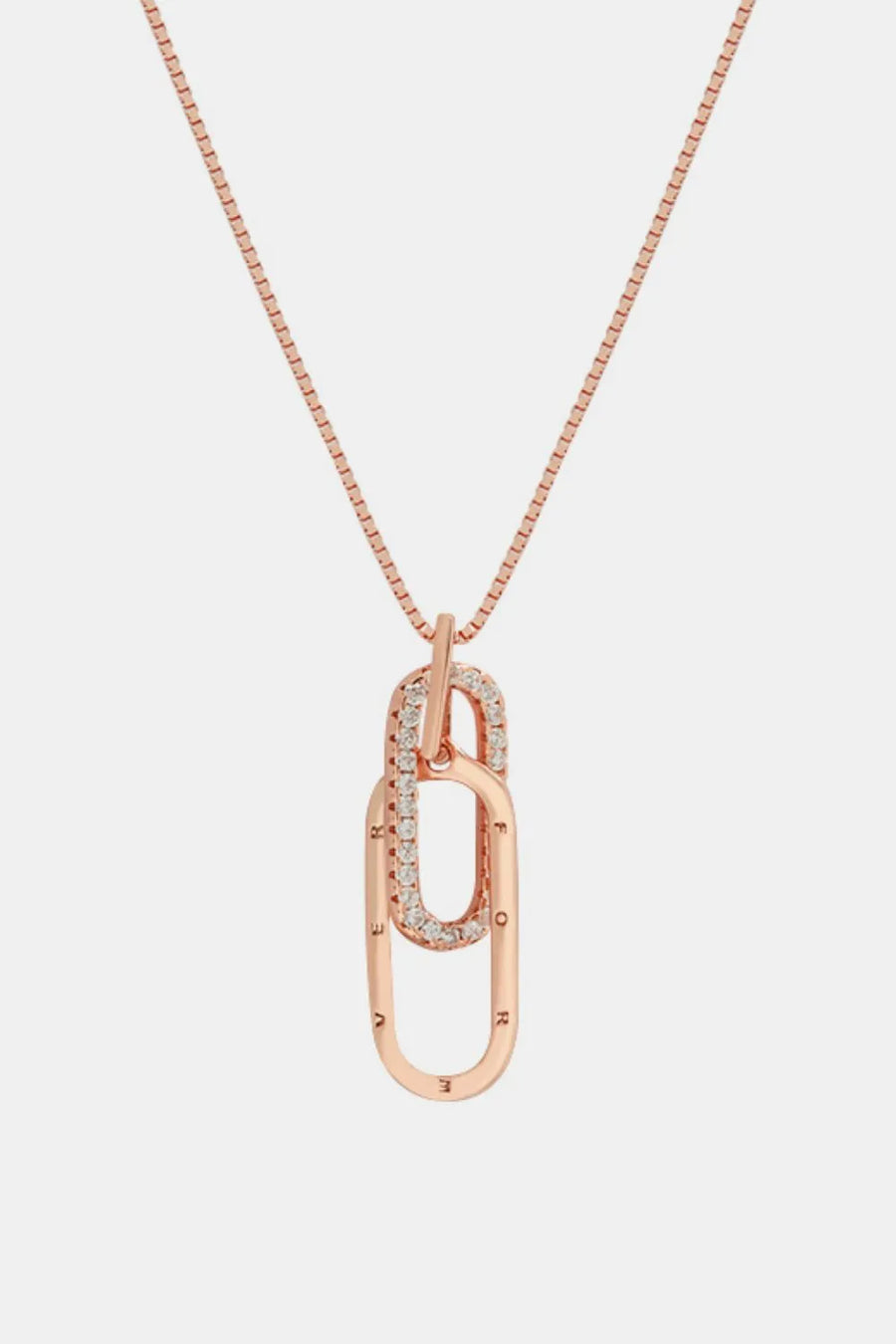 Rose gold necklace with a unique pendant on a light gray background
