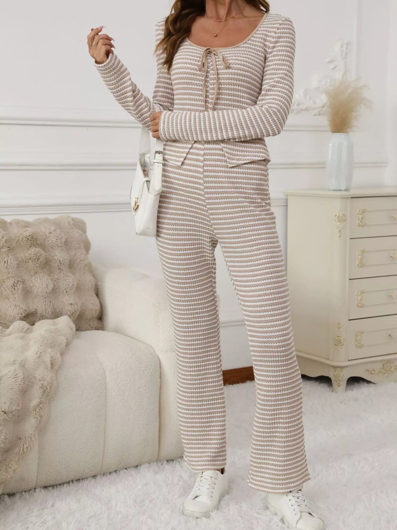 Person wearing a striped outfit in a cozy living room.