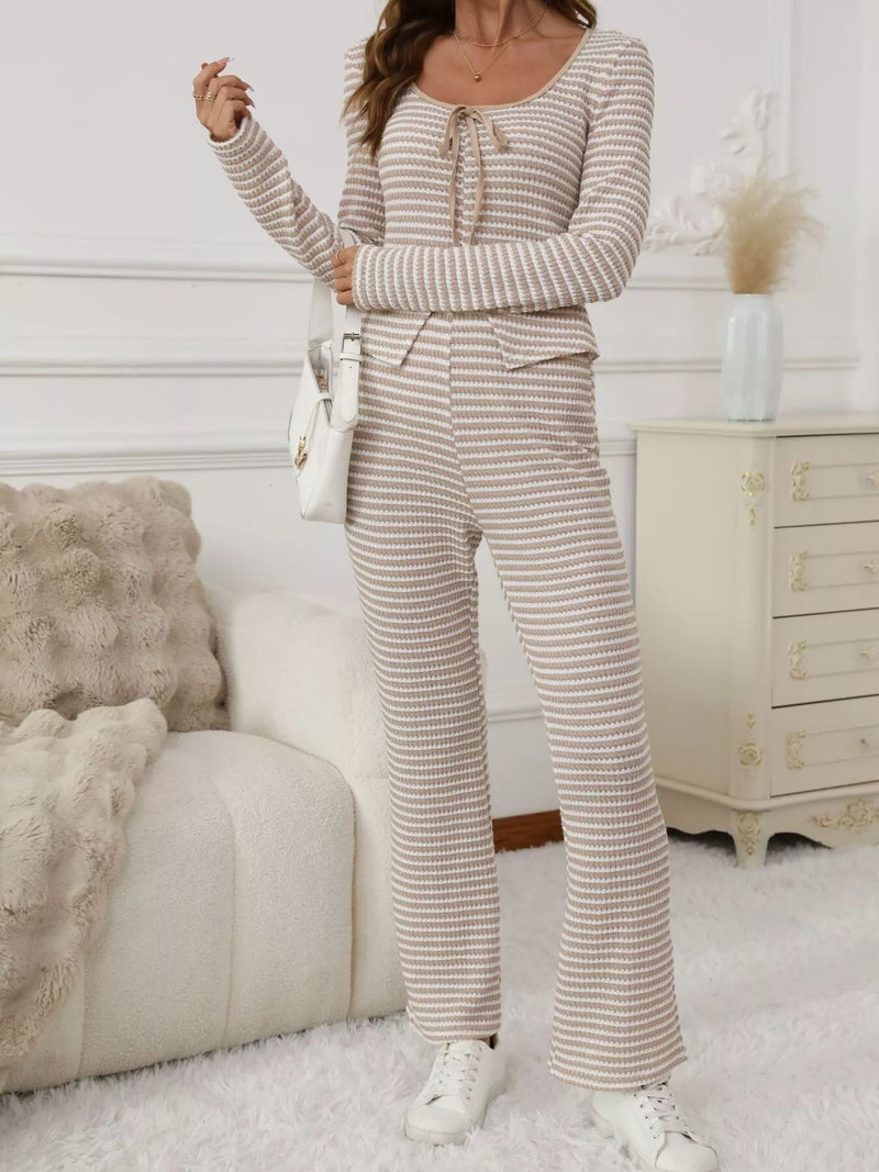 Person wearing a striped outfit in a cozy living room.