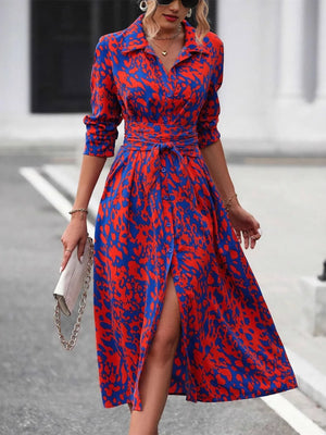 Woman wearing a red and blue patterned dress on a street.