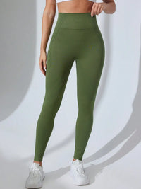 Person wearing green leggings on a white background