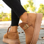 Woman showing the left boot she is wearing