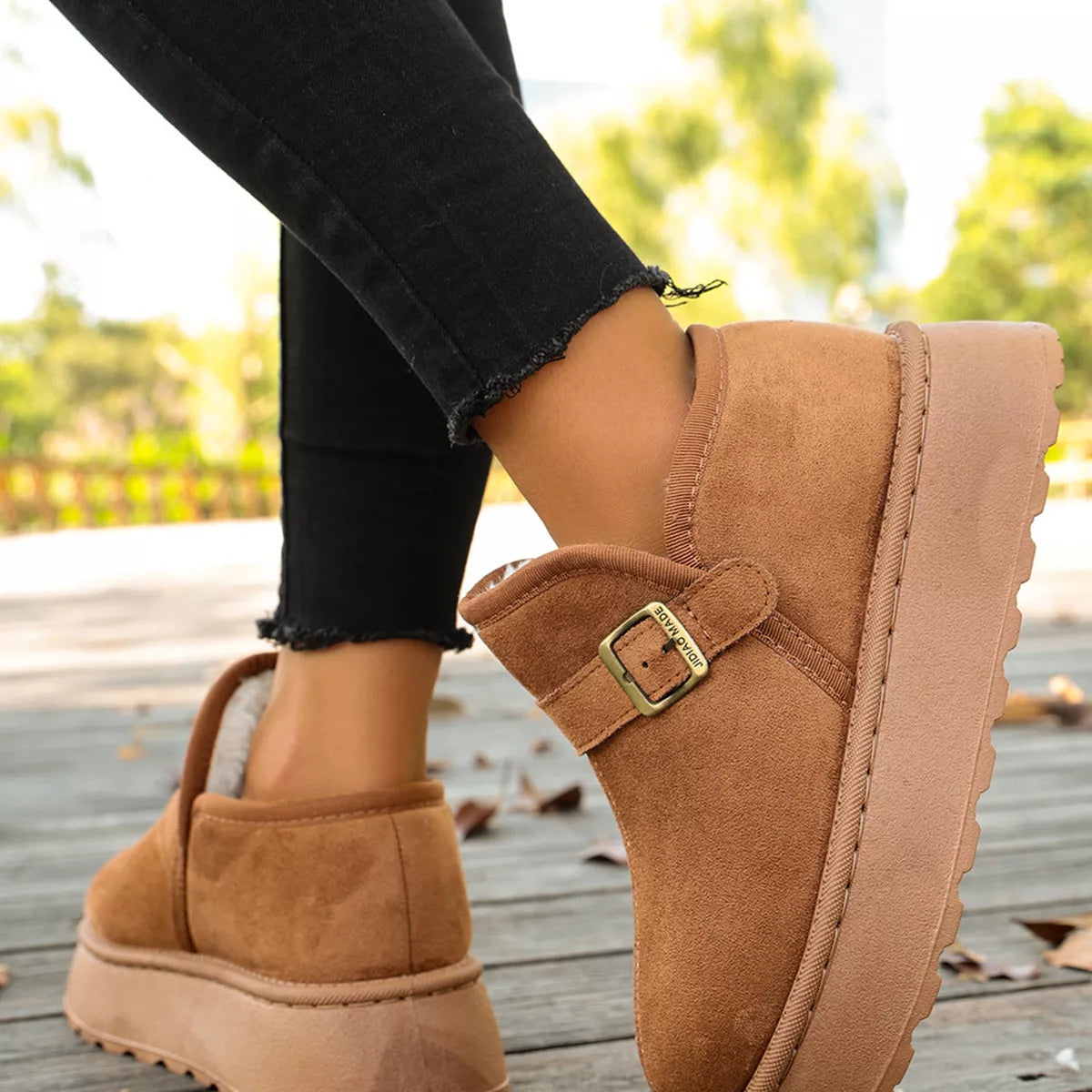 Woman showing the left boot she is wearing