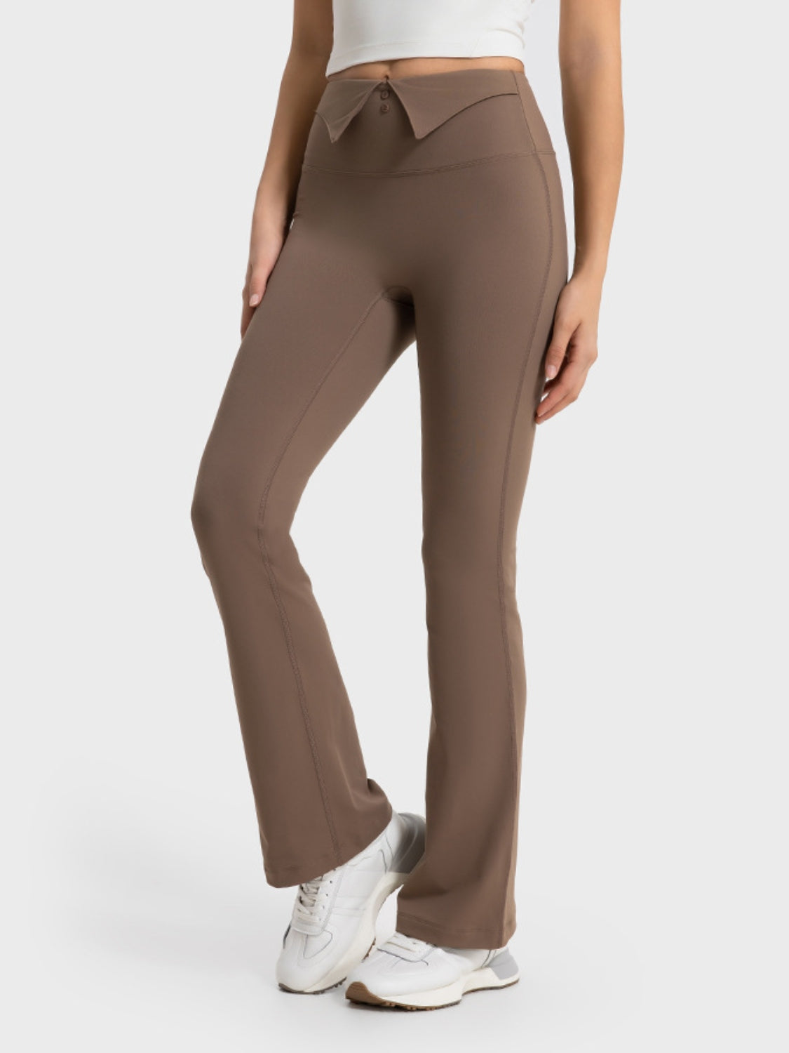 Brown pants worn by a person on a white background