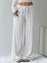 Striped pants worn by a person on a light gray background