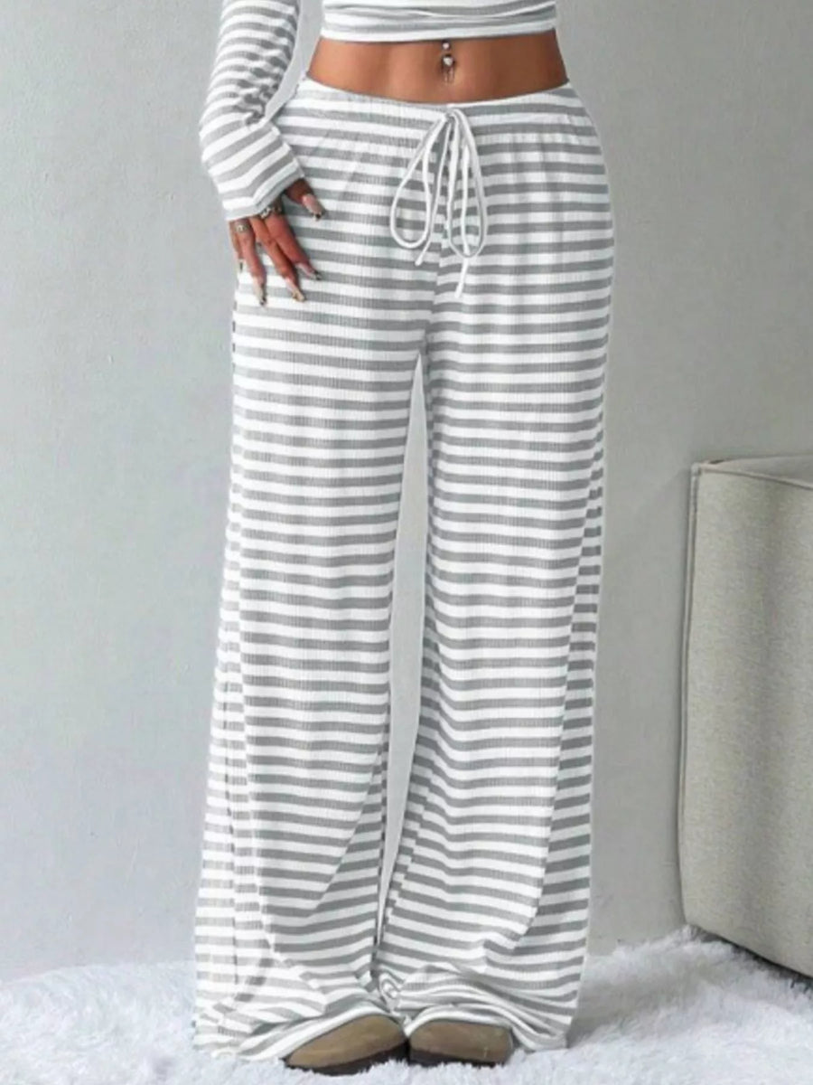 Striped pants worn by a person on a light gray background