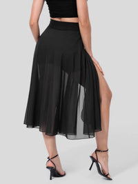 Black skirt with a high slit worn by a model on a gray background