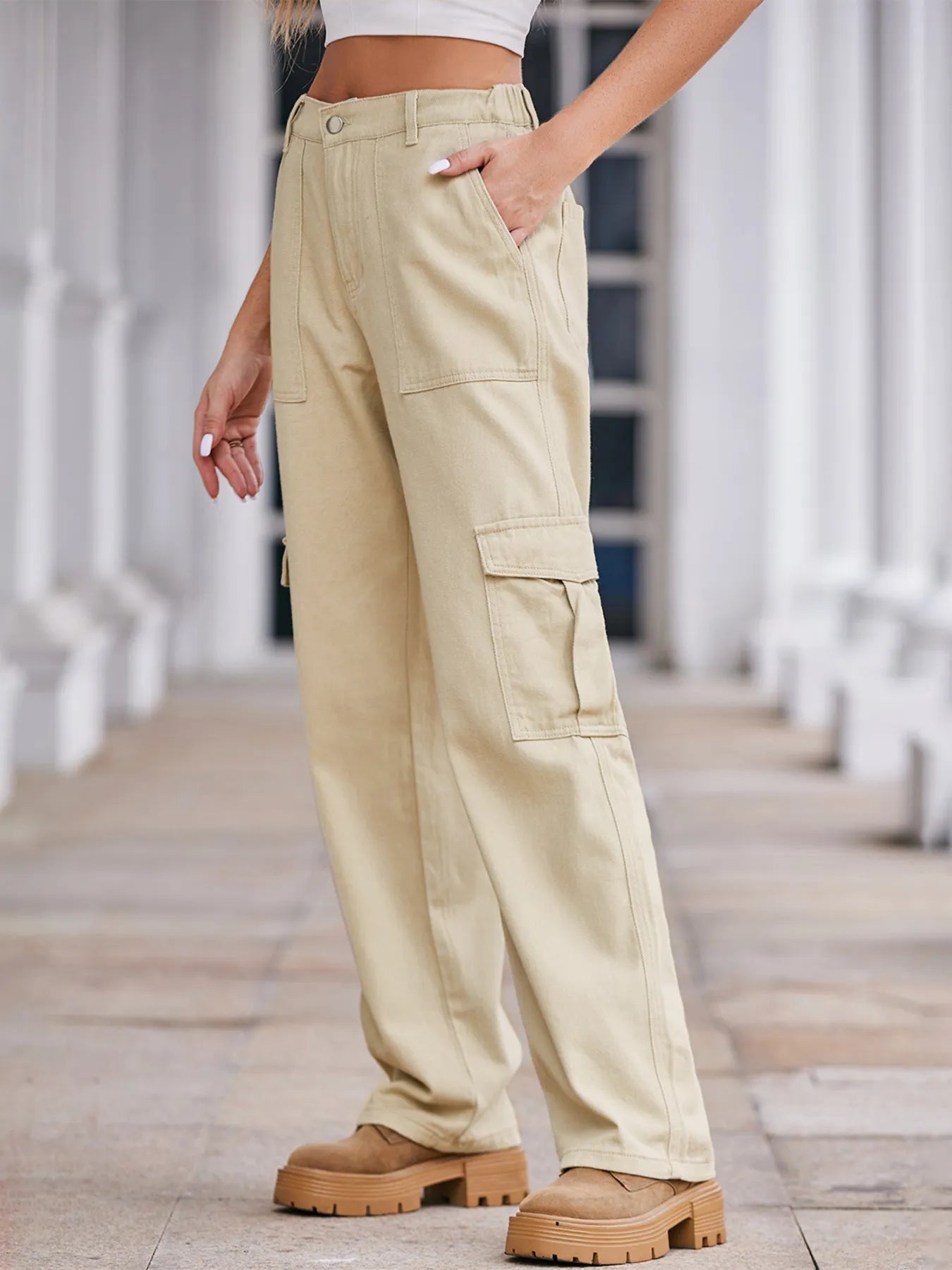 Person wearing beige cargo pants with a blurred background